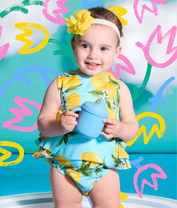 a-baby-girl-holding-a-cup