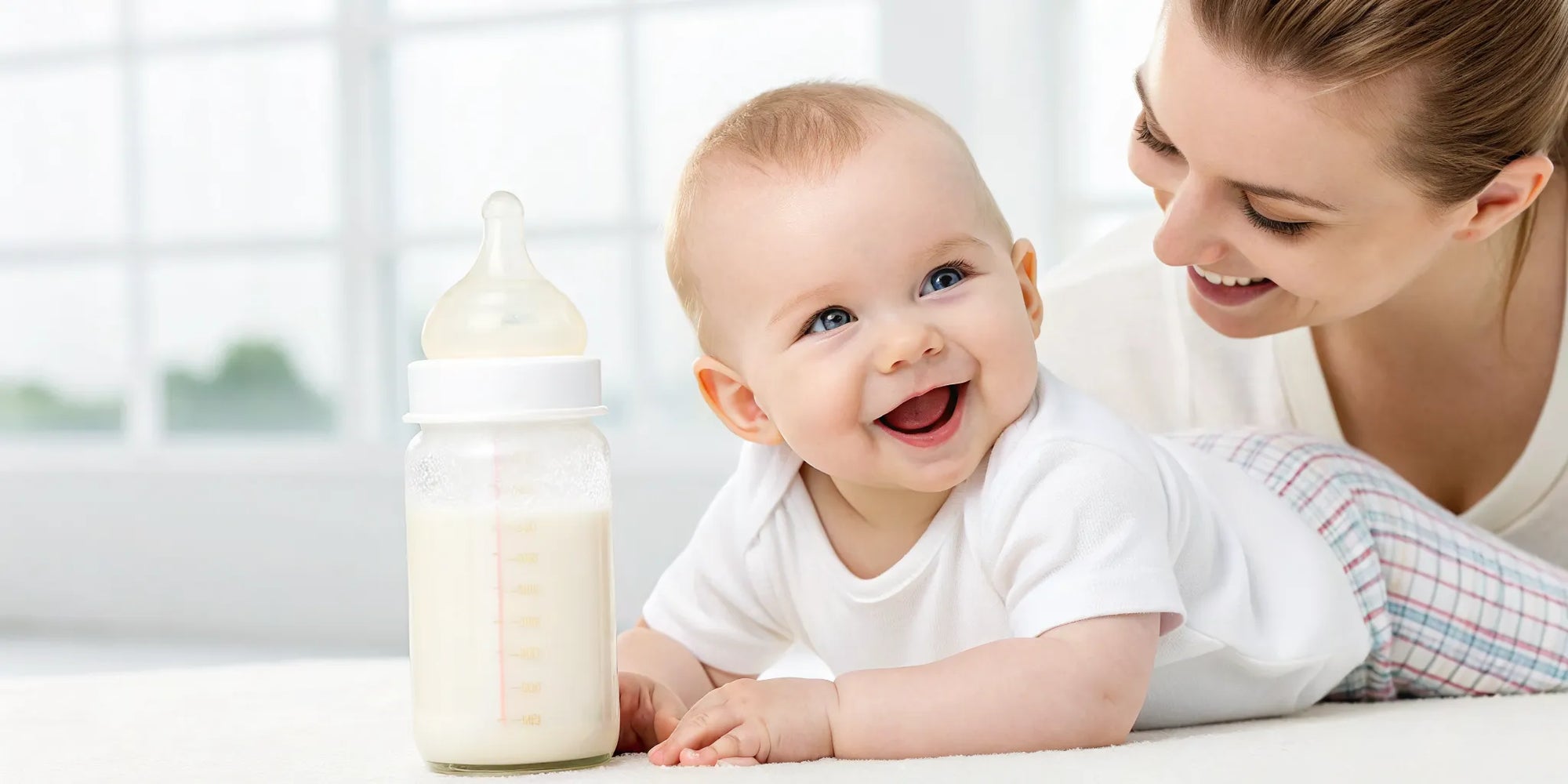 Happy baby with a bottle of gentle formula for gas relief, resting with a parent.