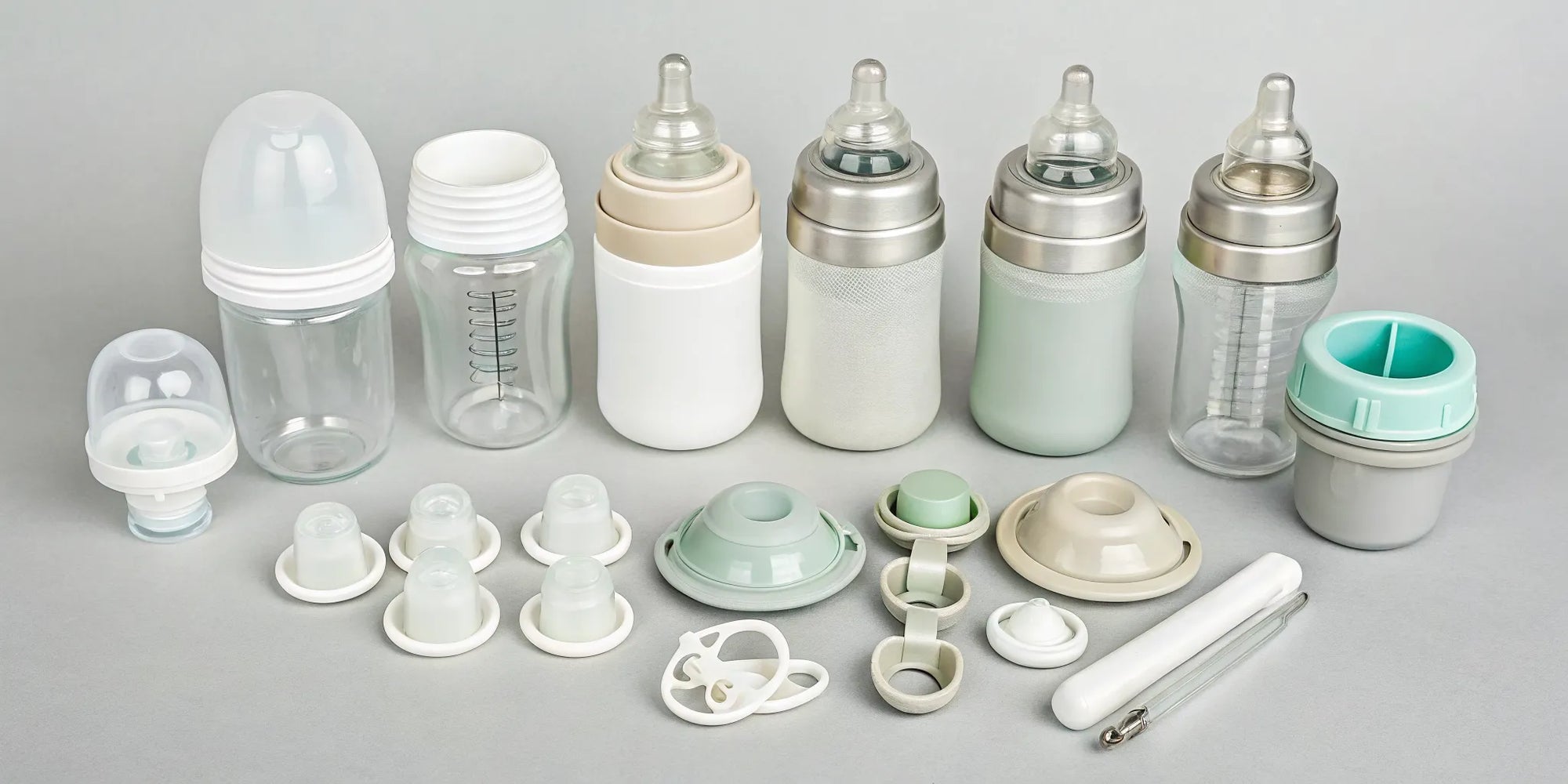 Different baby formula bottles and nipples arranged to test for compatibility.