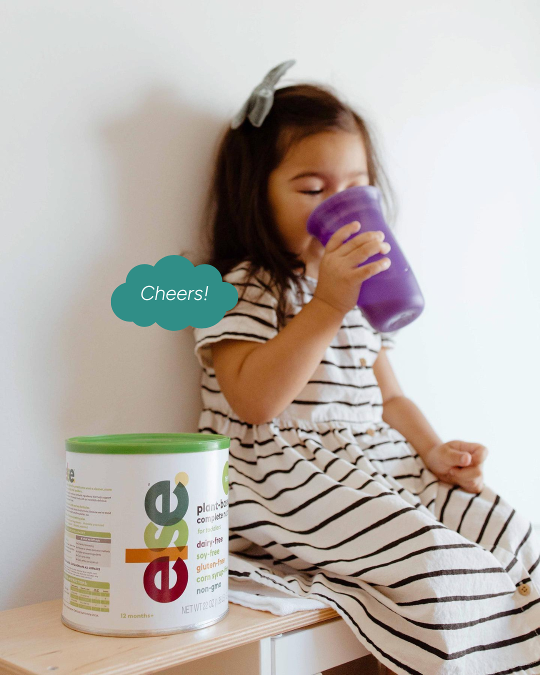 Toddler happily feeding on plant-based formula
