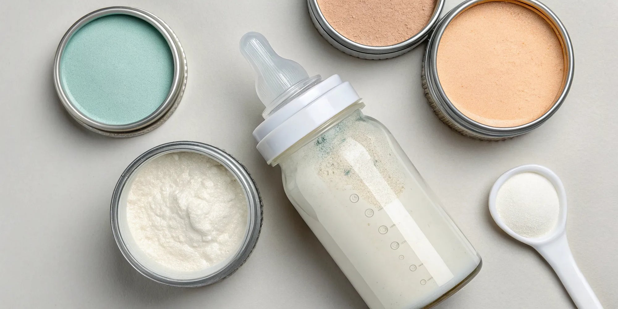 A bottle of baby formula and a container of powder for a constipated baby.