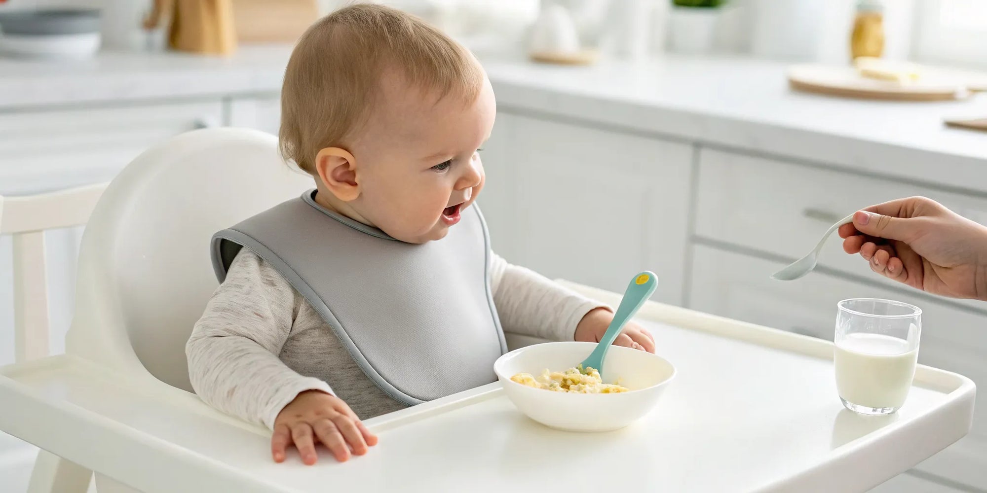 Baby eating cereal, a key time to spot signs of dairy intolerance.