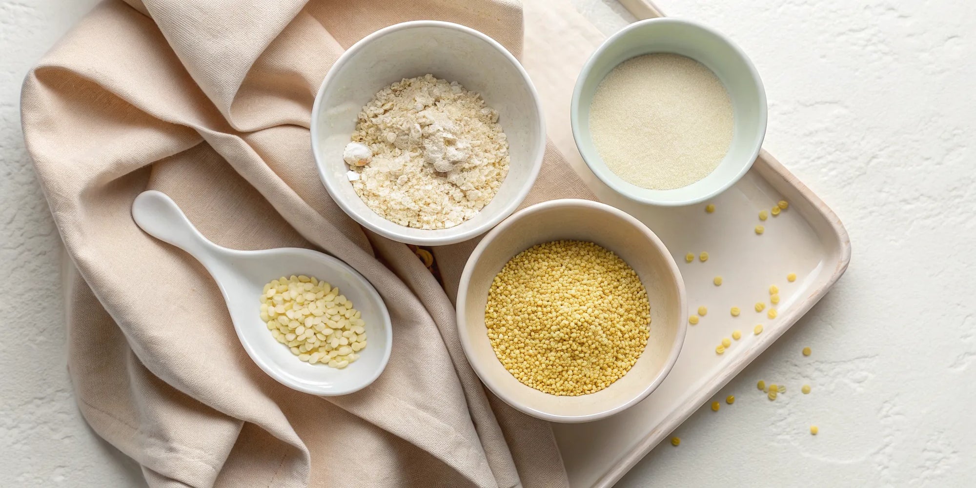 Bowls of the best eczema-friendly cereals for babies, including oats and millet.