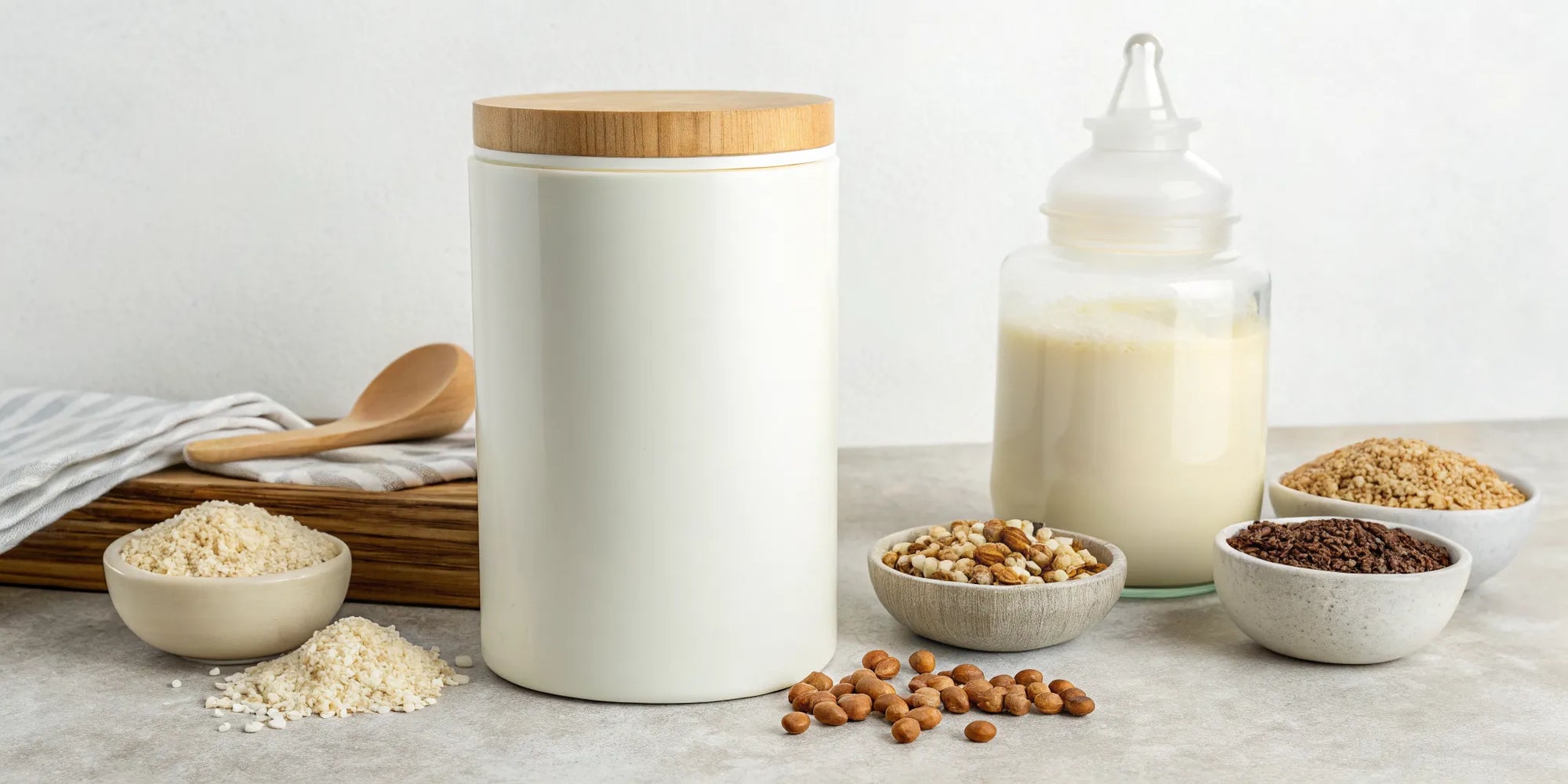 Dairy-free whole food formula powder and ingredients with a prepared baby bottle.