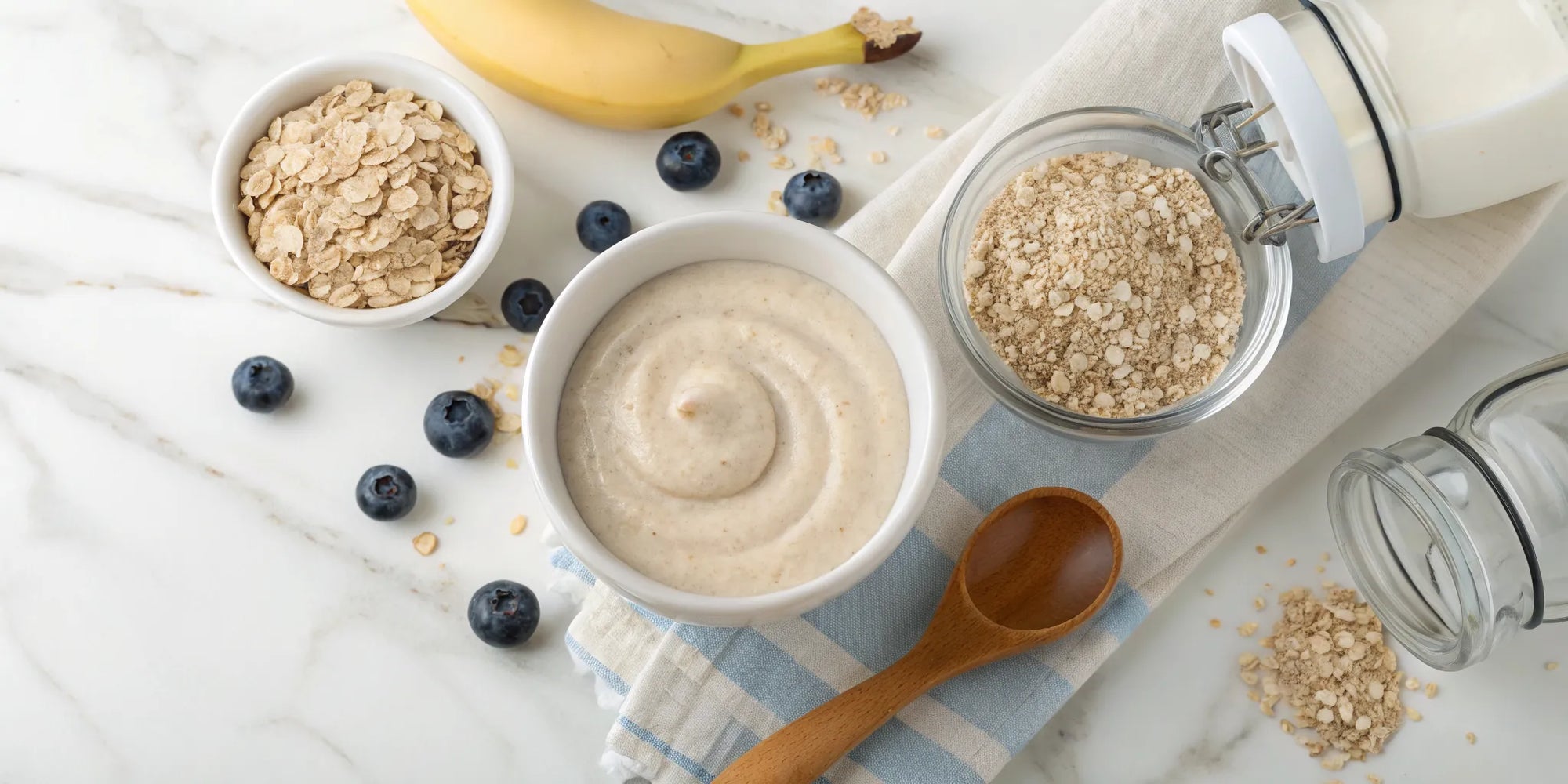 A bowl of safe oatmeal baby cereal with banana and blueberries.